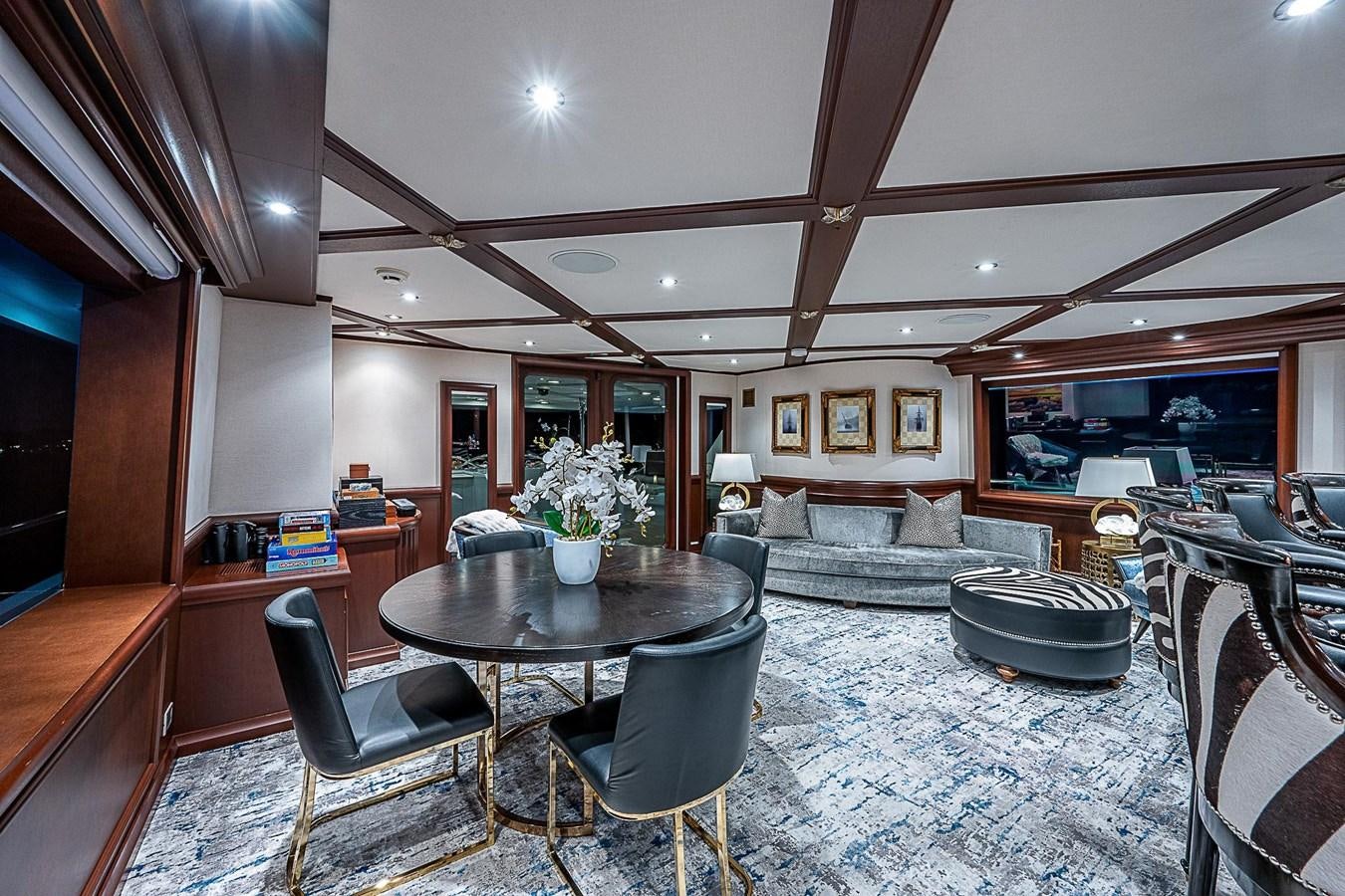 a living room with a couch and a table aboard LAGNIAPPE Yacht for Sale