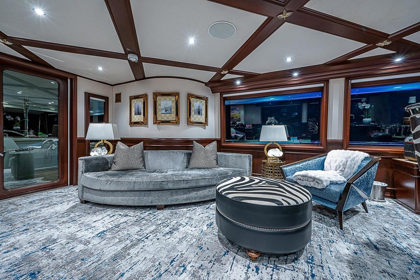 a living room with a large sofa aboard LAGNIAPPE Yacht for Sale