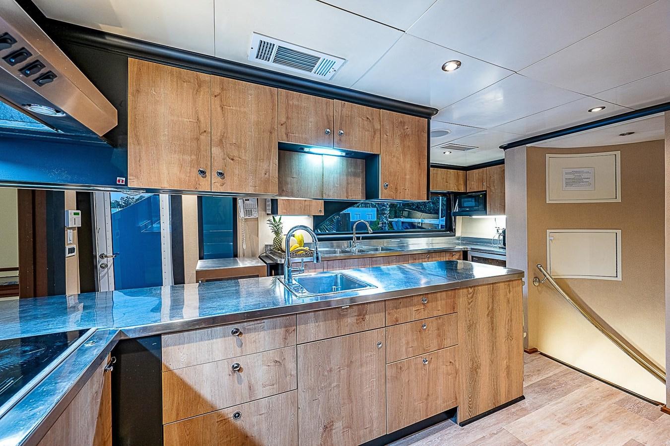 a kitchen with wooden cabinets aboard LAGNIAPPE Yacht for Sale