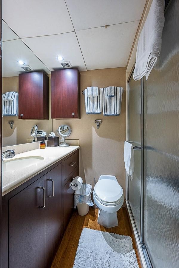 a bathroom with a shower and toilet aboard LAGNIAPPE Yacht for Sale