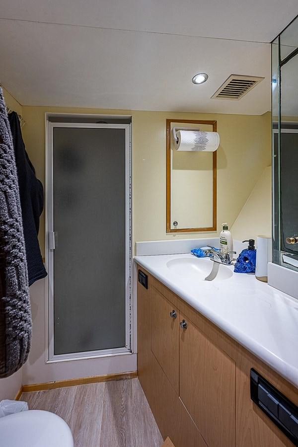 a bathroom with a mirror and sink aboard LAGNIAPPE Yacht for Sale
