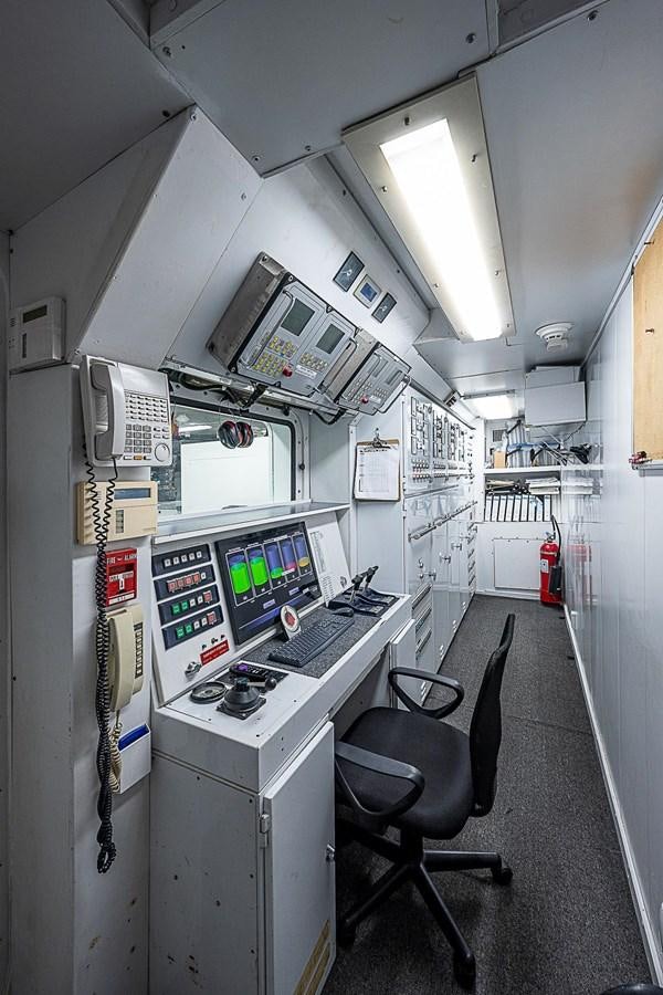 a control room with a chair and computer aboard LAGNIAPPE Yacht for Sale