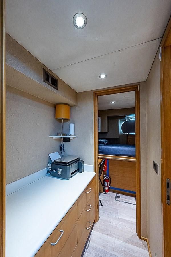 a room with a bed and desk aboard LAGNIAPPE Yacht for Sale