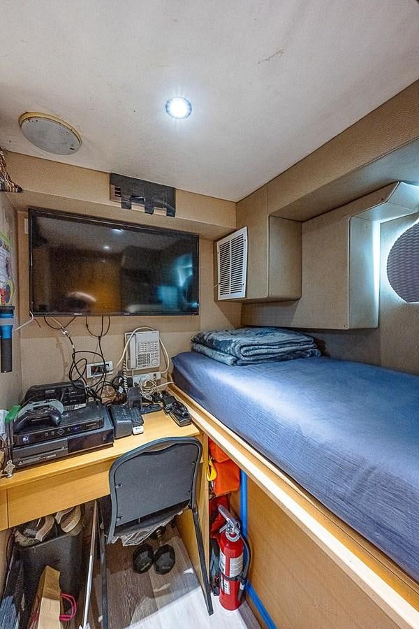 a room with a bed and a fan aboard LAGNIAPPE Yacht for Sale