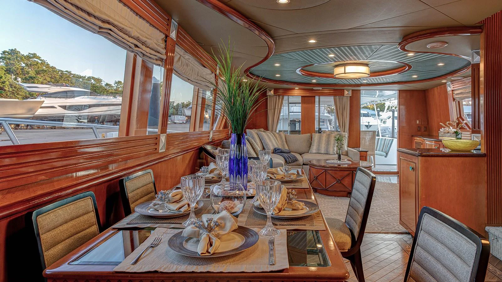 a dining table with glasses and a view of the mountains aboard SIR JON II Yacht for Sale