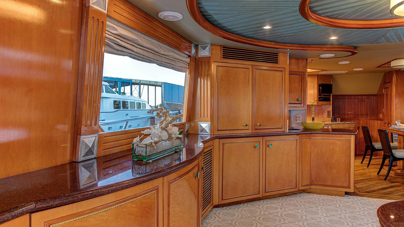 a kitchen with wooden cabinets aboard SIR JON II Yacht for Sale