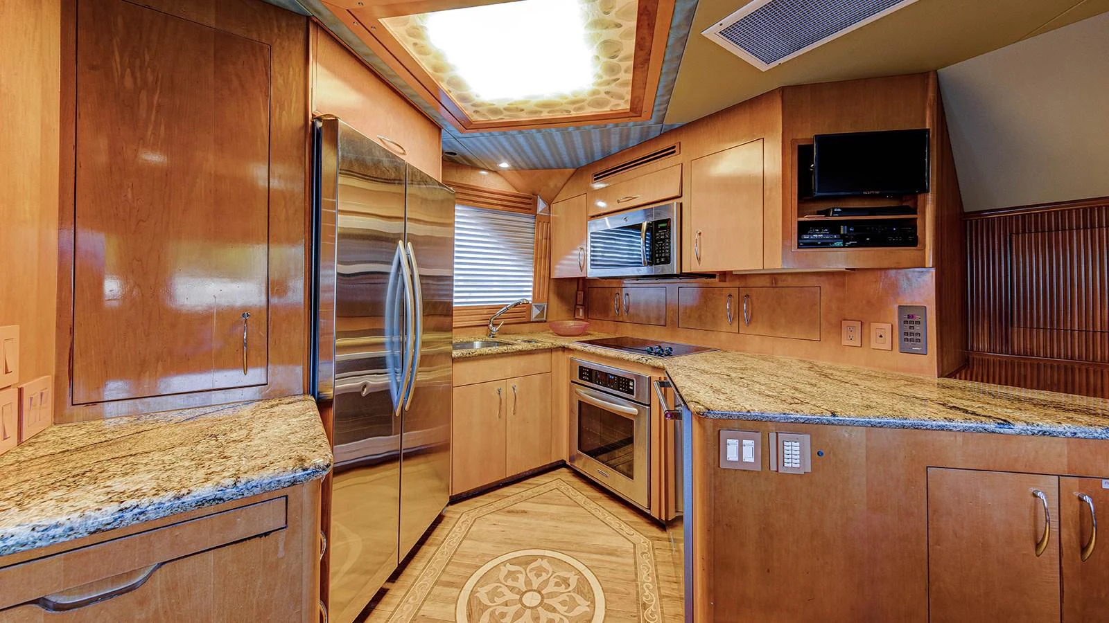 a kitchen with wooden cabinets aboard SIR JON II Yacht for Sale