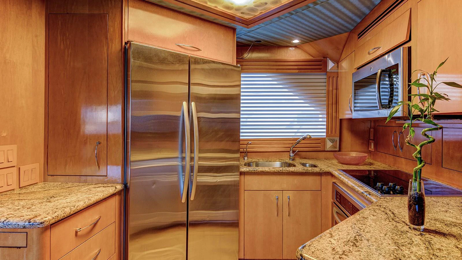 a kitchen with a stainless steel refrigerator aboard SIR JON II Yacht for Sale