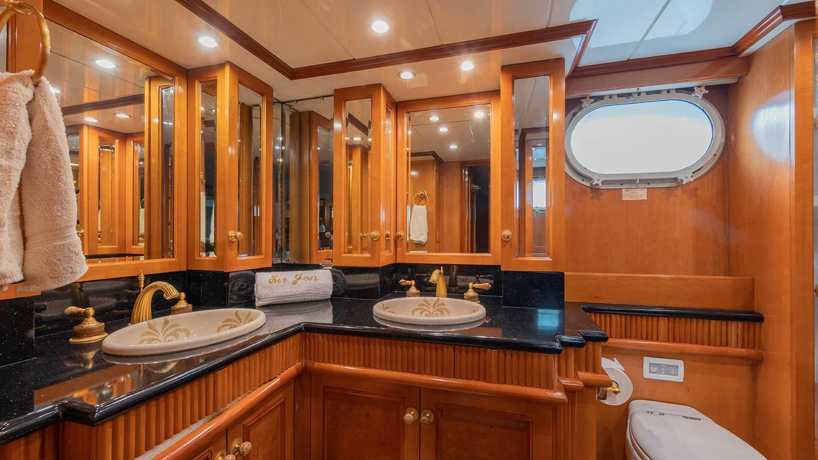 a bathroom with wooden cabinets aboard SIR JON II Yacht for Sale