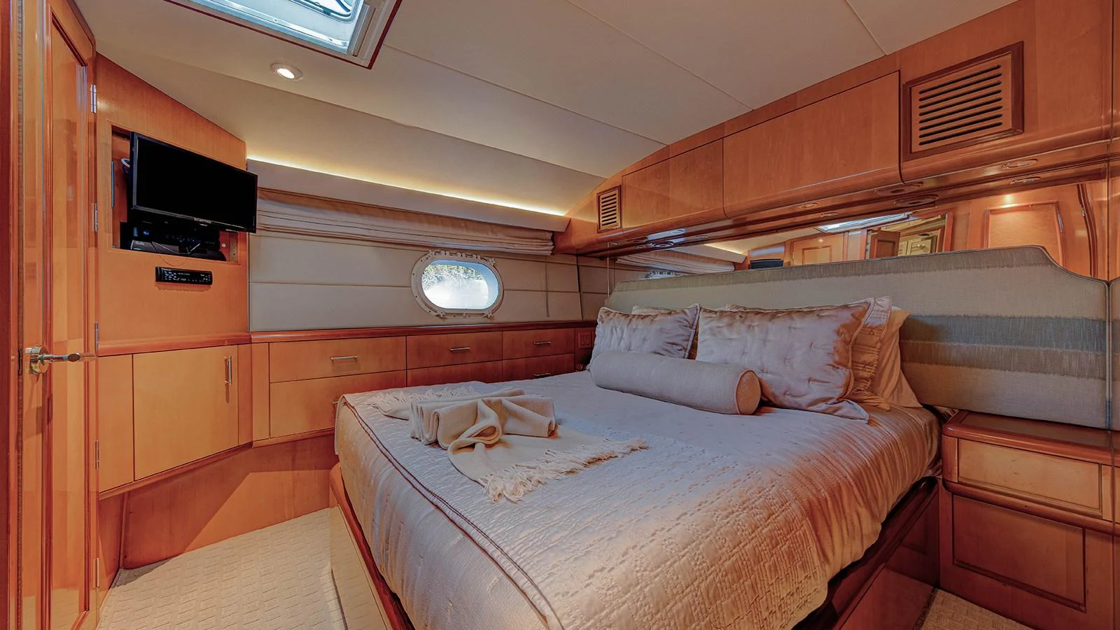 a room with a bed and a television aboard SIR JON II Yacht for Sale