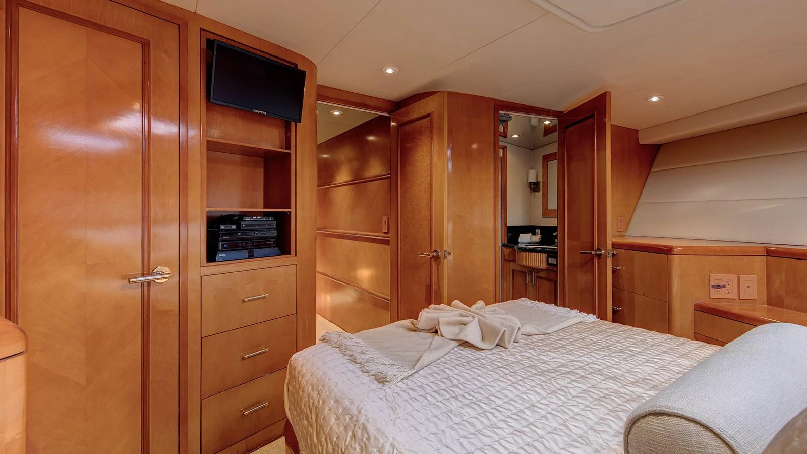 a bedroom with a bed and a television aboard SIR JON II Yacht for Sale