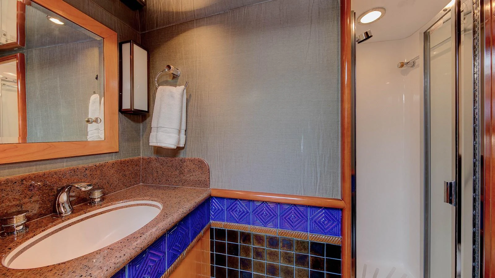 a bathroom with a sink and mirror aboard SIR JON II Yacht for Sale
