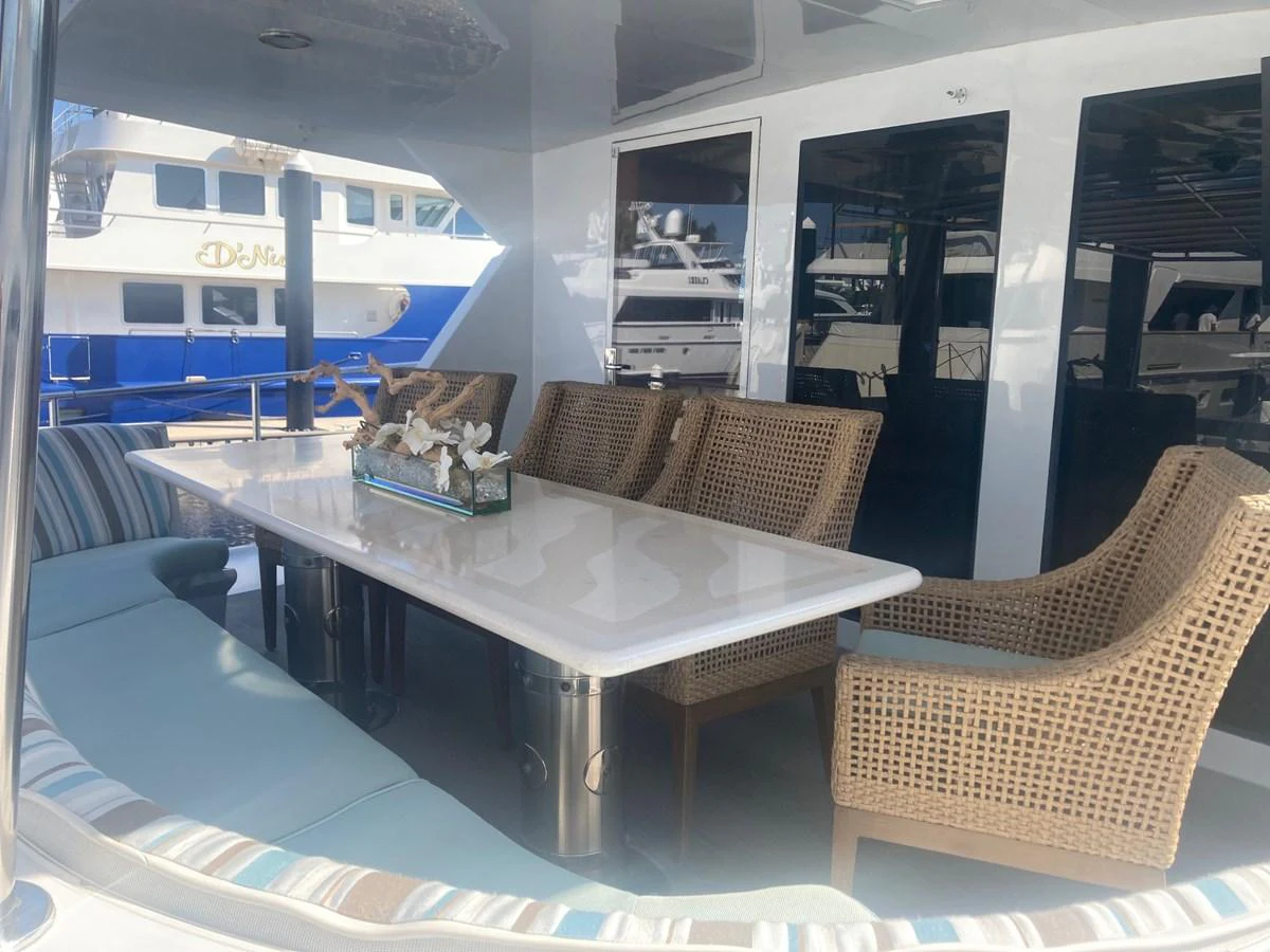 a table and chairs on a boat aboard SIR JON II Yacht for Sale