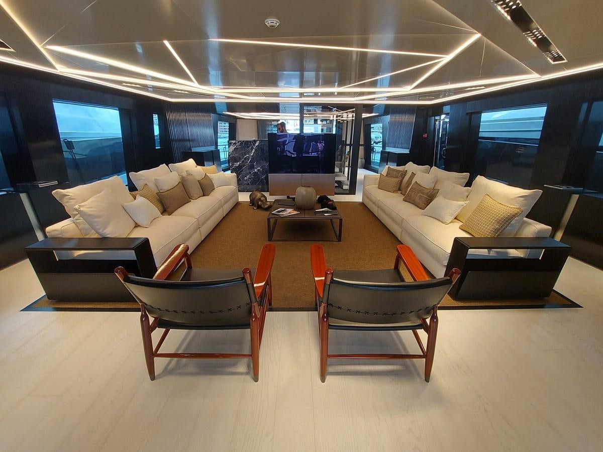 a room with a couch and a table and chairs aboard M 125 Yacht for Sale