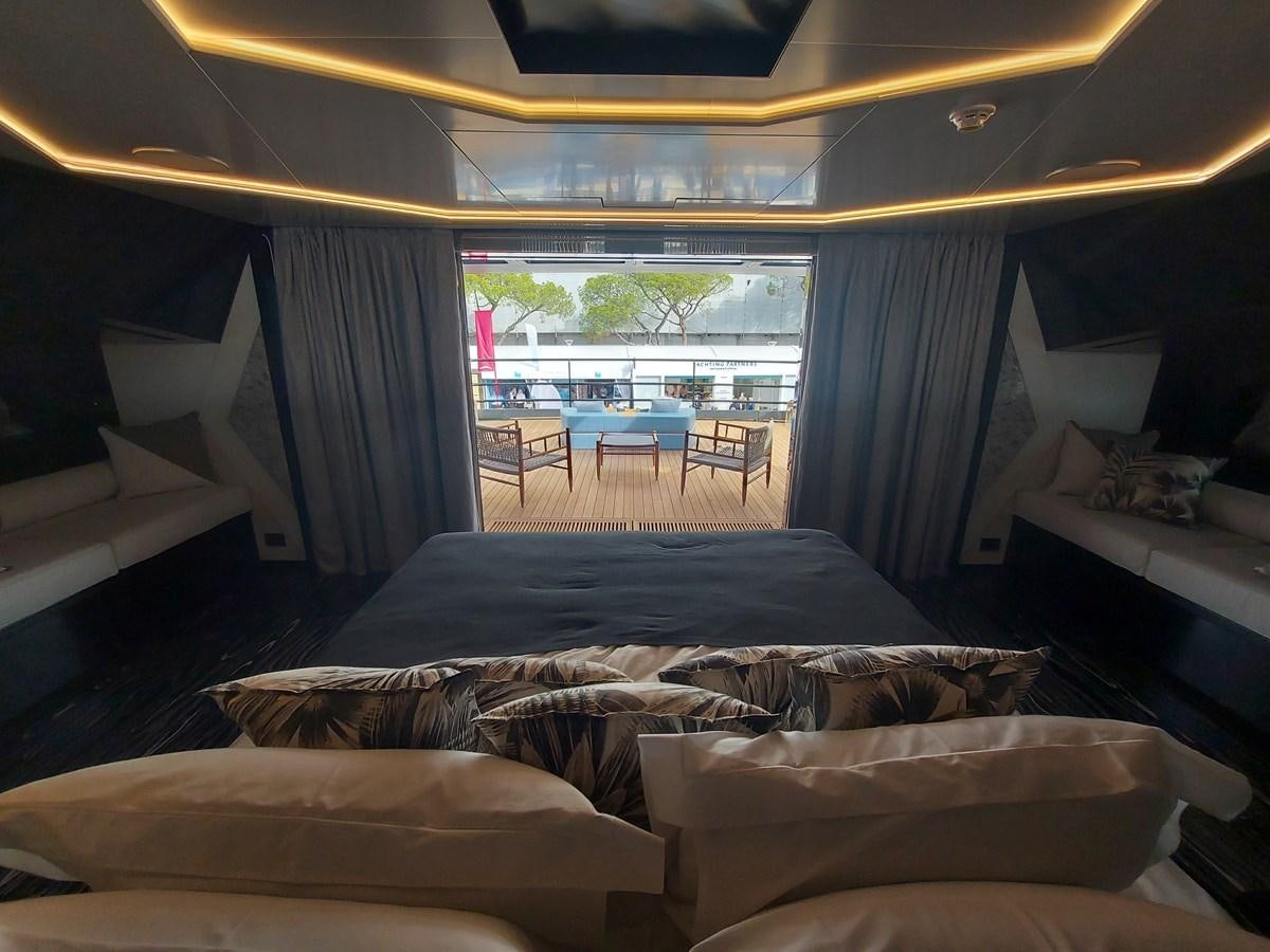 a room with a bed and a table and chairs aboard M 125 Yacht for Sale