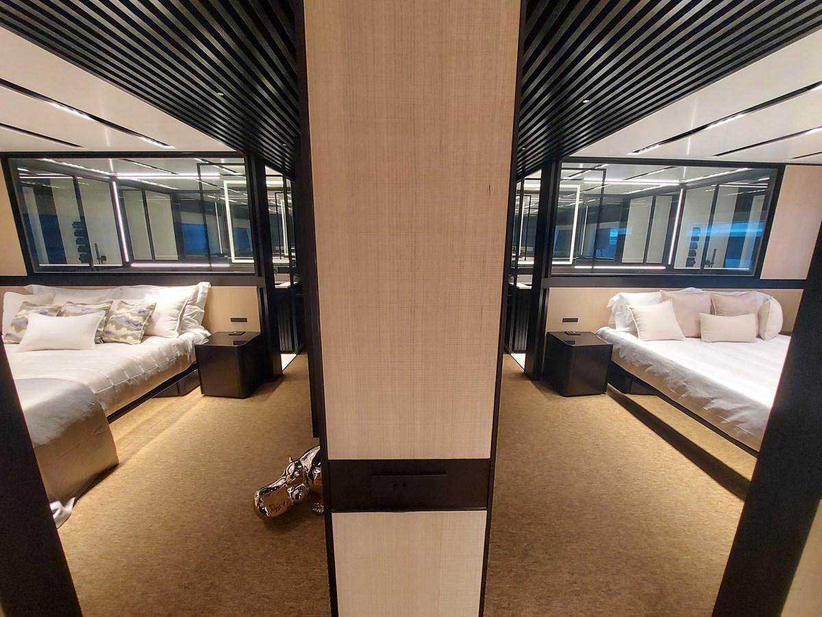 a room with a bed and a couch aboard M 125 Yacht for Sale