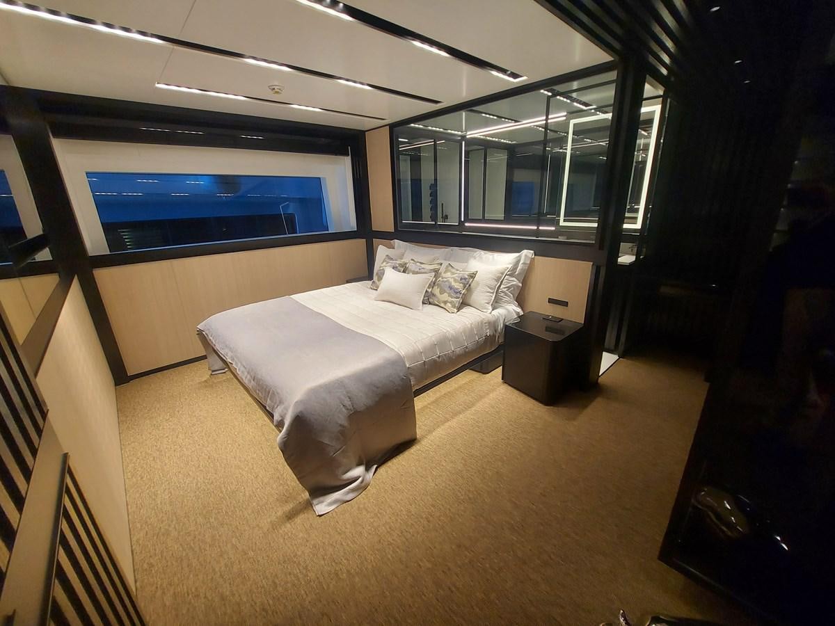 a room with a bed and a tv aboard M 125 Yacht for Sale