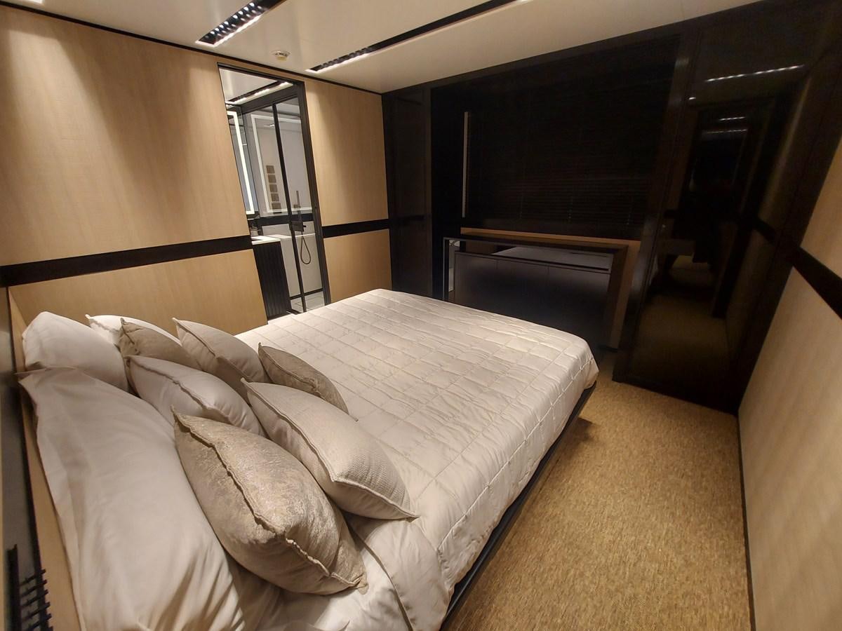 a bed with white sheets aboard M 125 Yacht for Sale