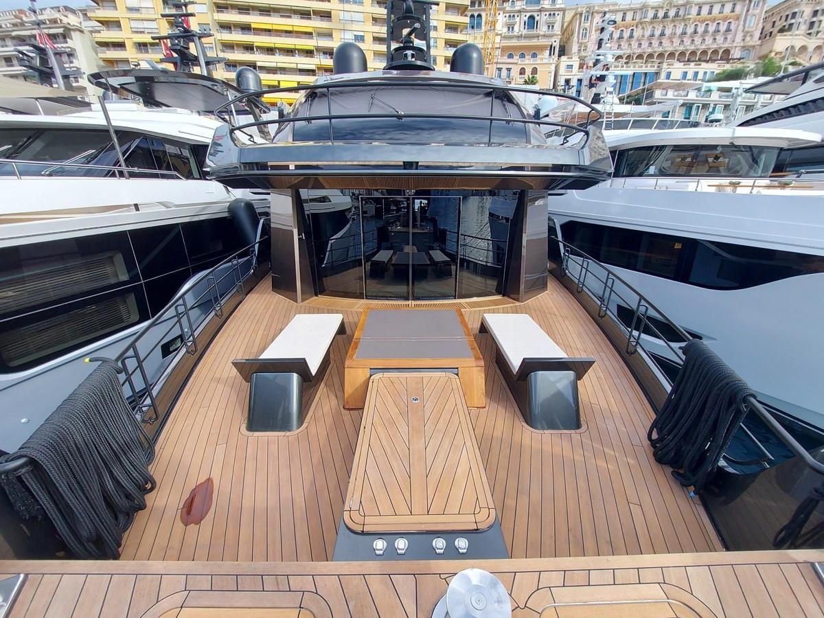 a deck with a table and chairs aboard M 125 Yacht for Sale