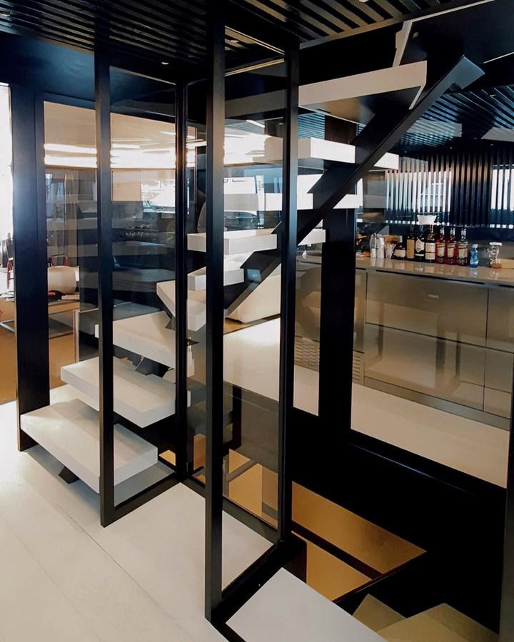 a room with a large glass wall aboard M 125 Yacht for Sale