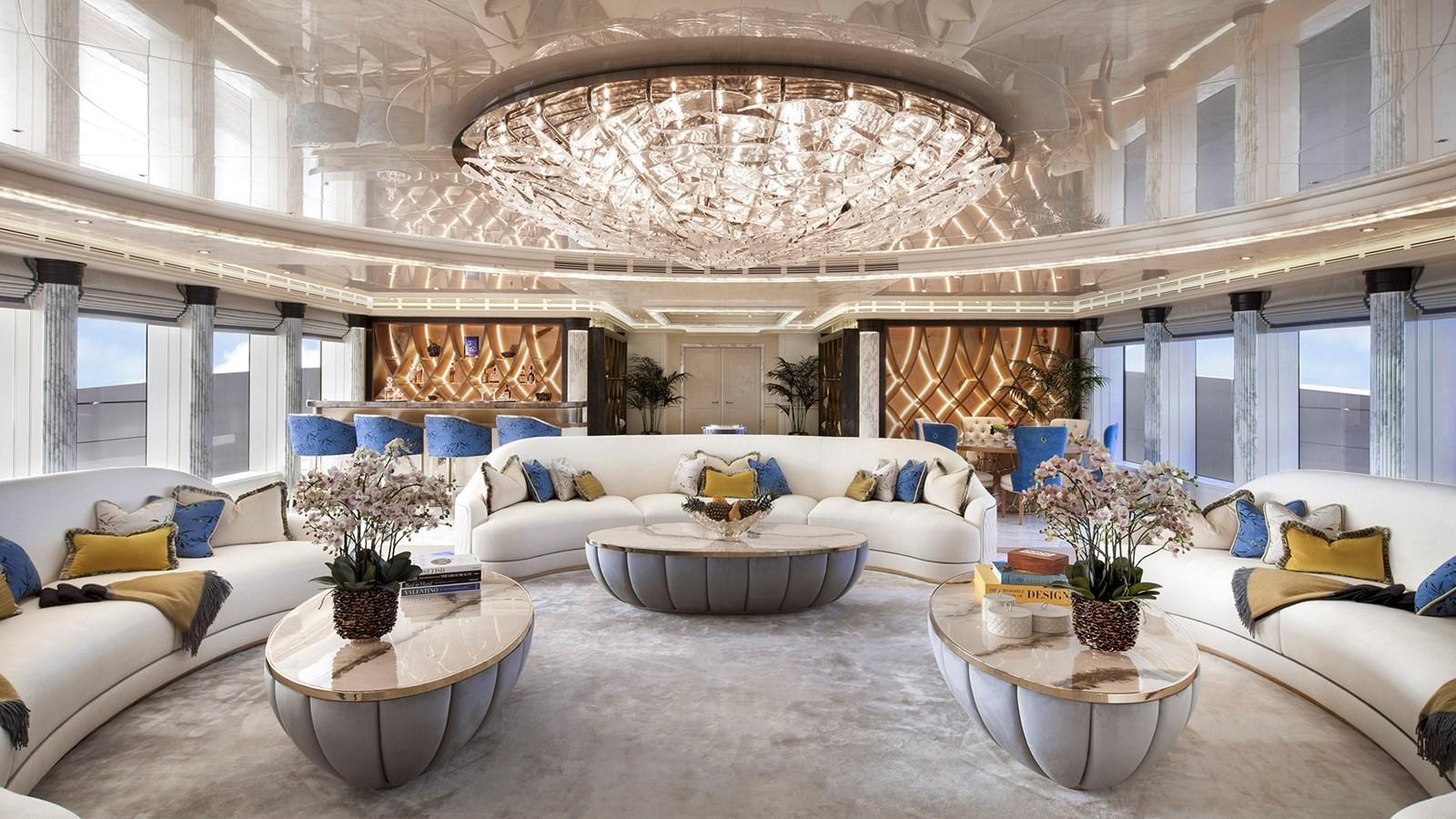 a large living room with a large chandelier aboard AHPO Yacht for Sale