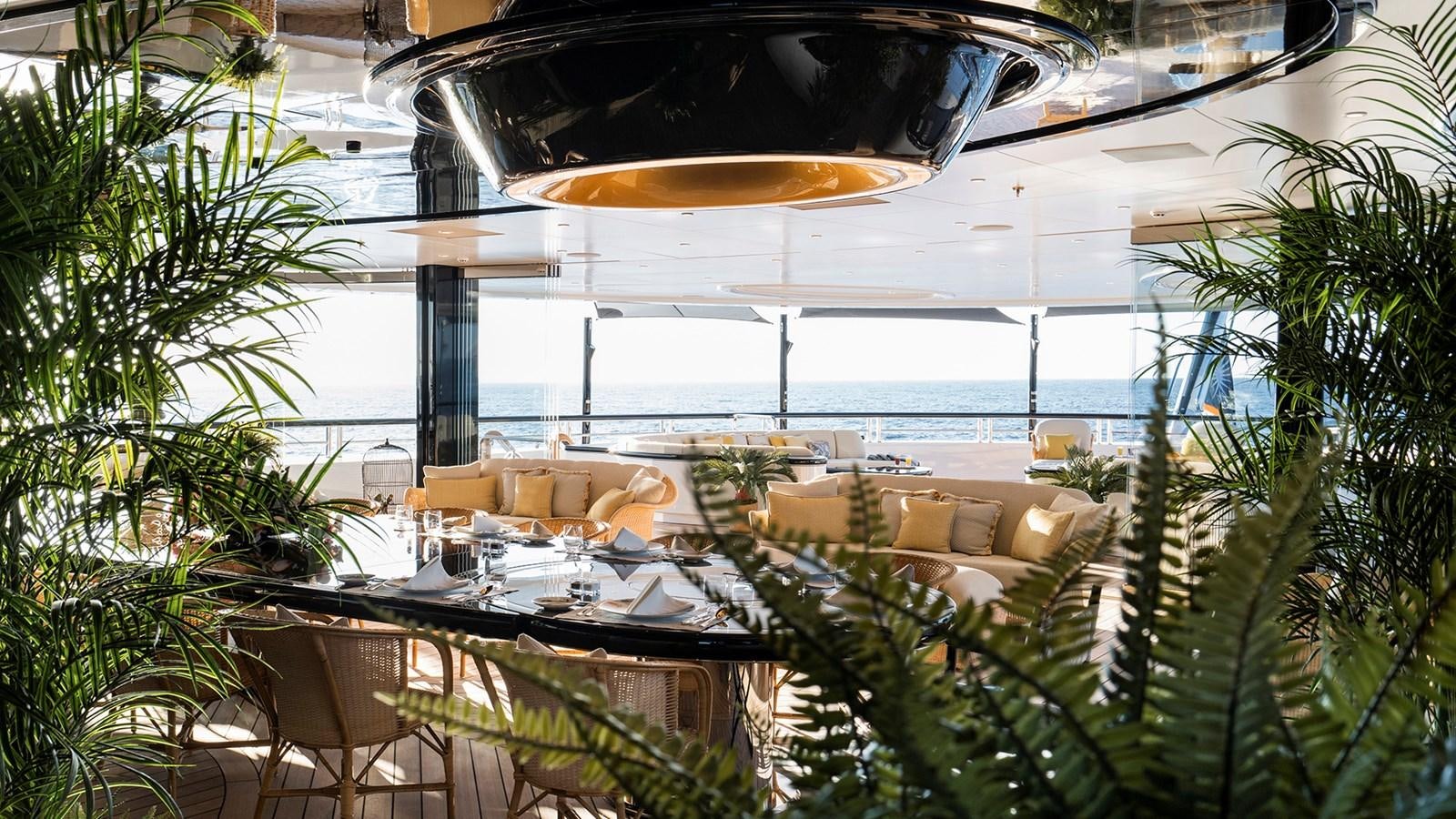 a large room with a table and chairs aboard AHPO Yacht for Sale