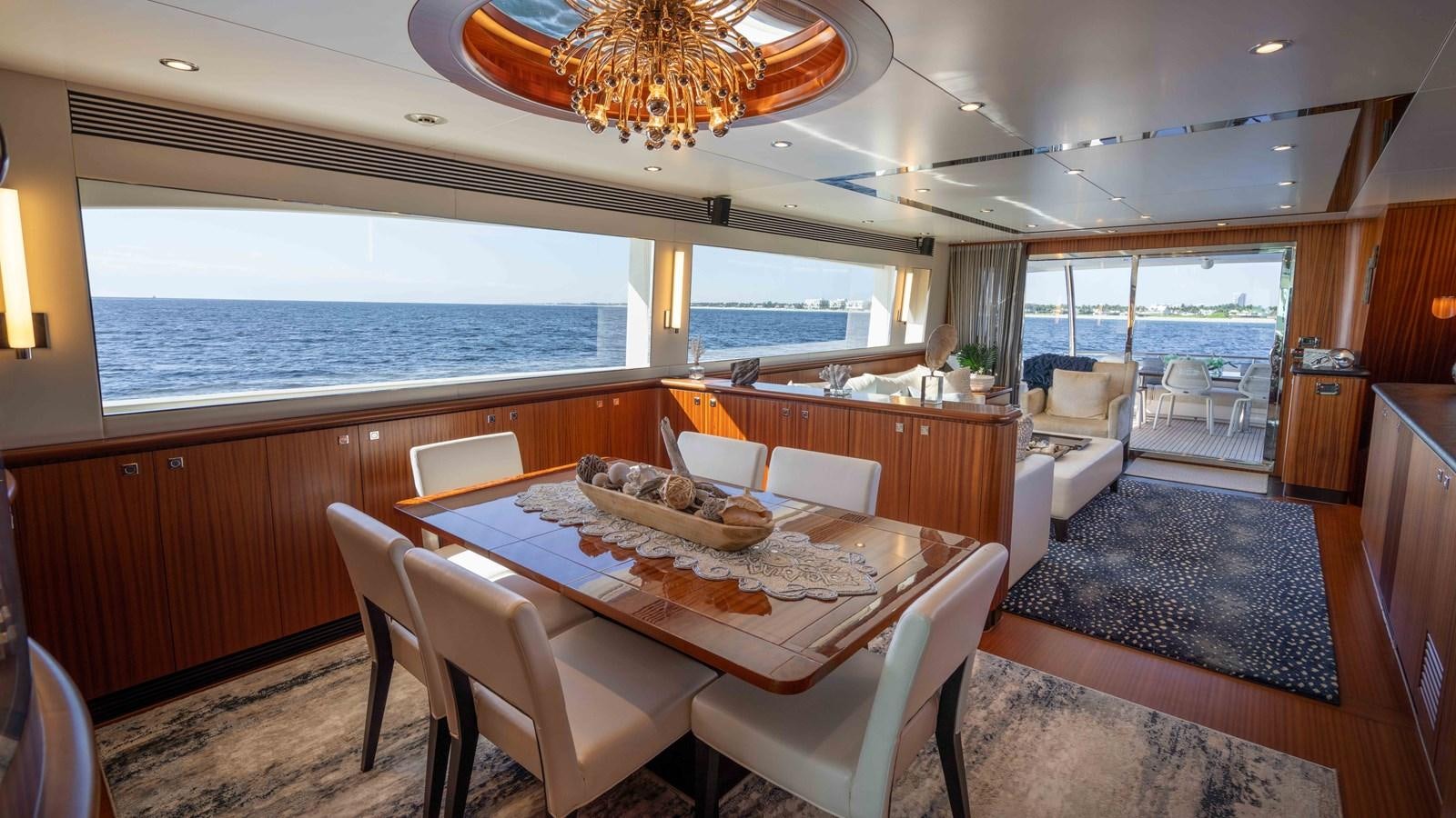 a dining room with a large window aboard E84 Yacht for Sale