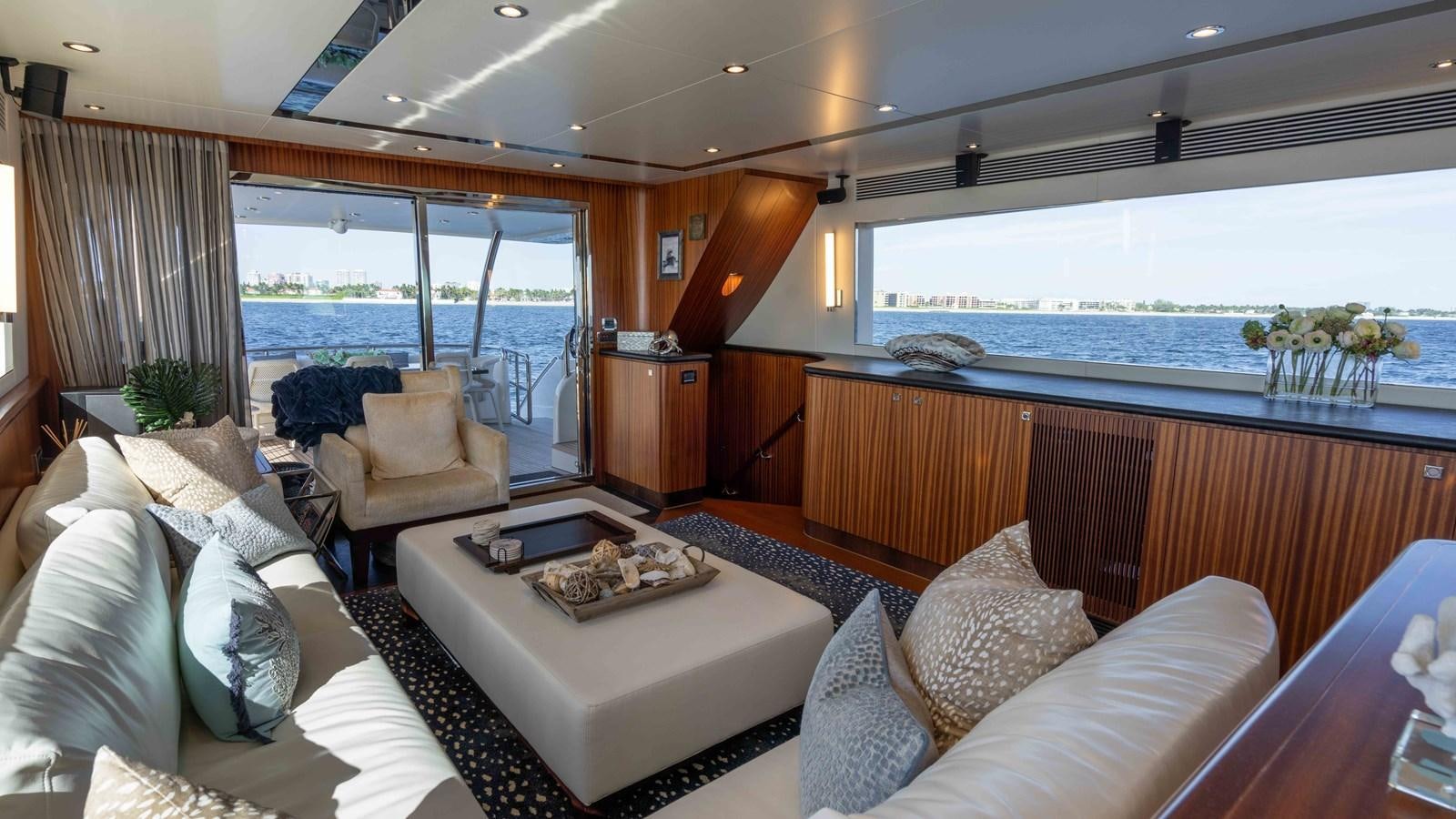 a living room with a large window aboard E84 Yacht for Sale