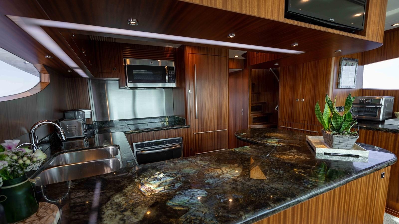 a kitchen with a marble counter top aboard E84 Yacht for Sale