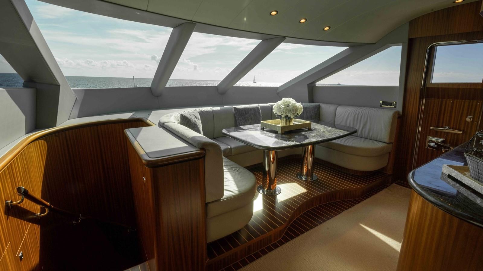 a living room with a table and couches aboard E84 Yacht for Sale