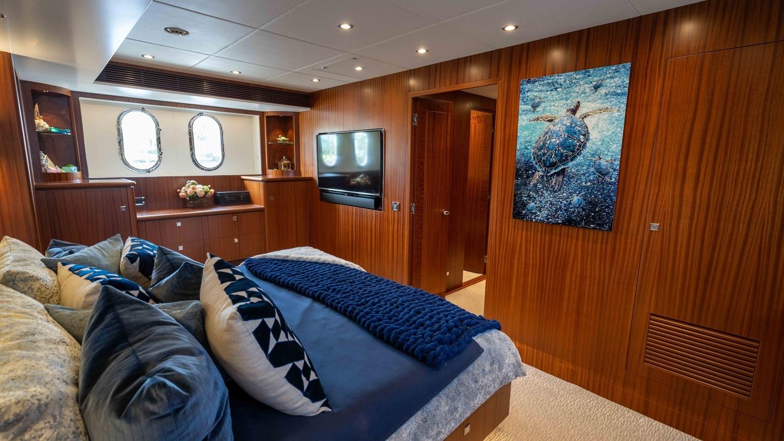 a room with a couch and a television aboard E84 Yacht for Sale