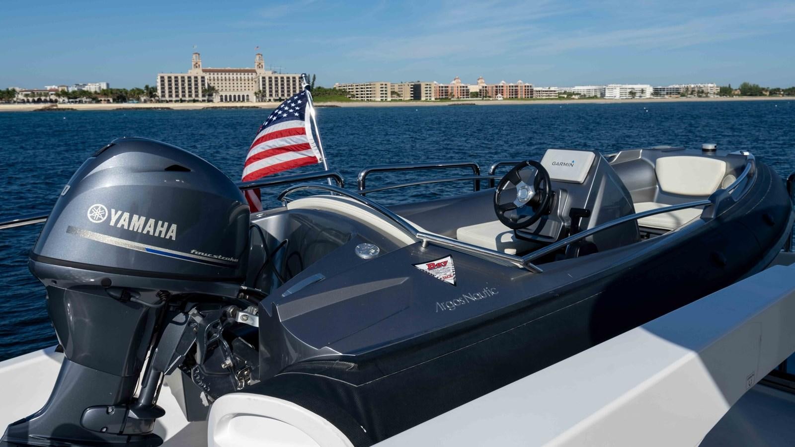a boat with a flag on the front aboard E84 Yacht for Sale