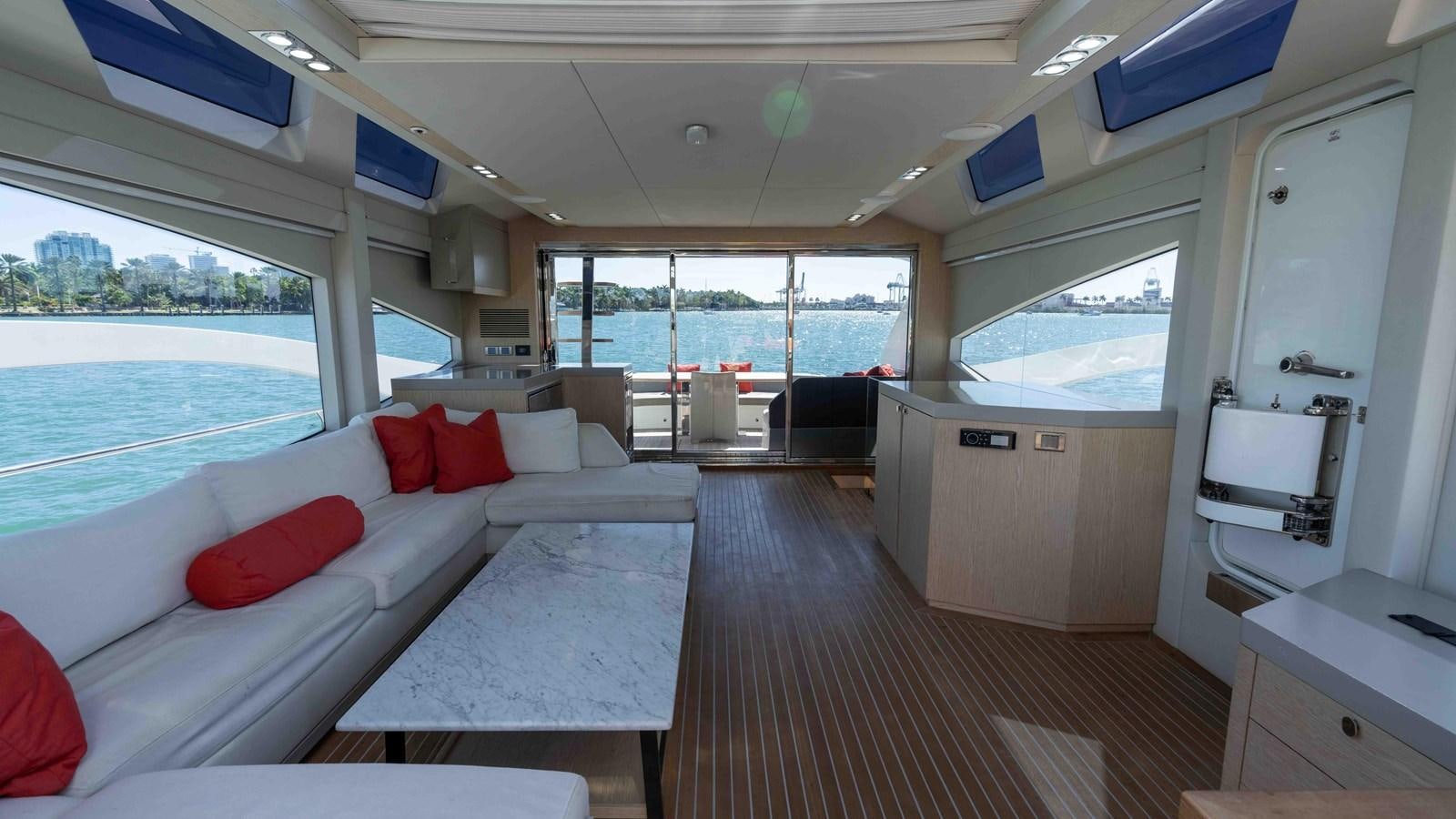 a room with a bed and a table and a window aboard ADONIS Yacht for Sale