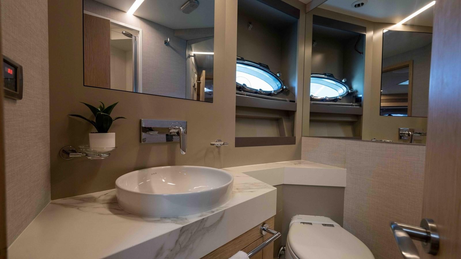 a bathroom with a sink and a mirror aboard ADONIS Yacht for Sale