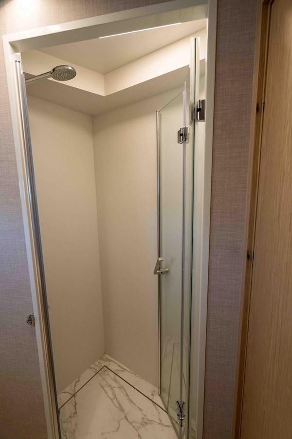 a bathroom with a glass shower aboard ADONIS Yacht for Sale