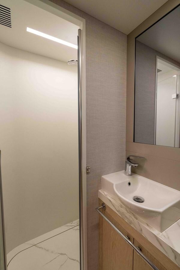 a bathroom with a sink and mirror aboard ADONIS Yacht for Sale