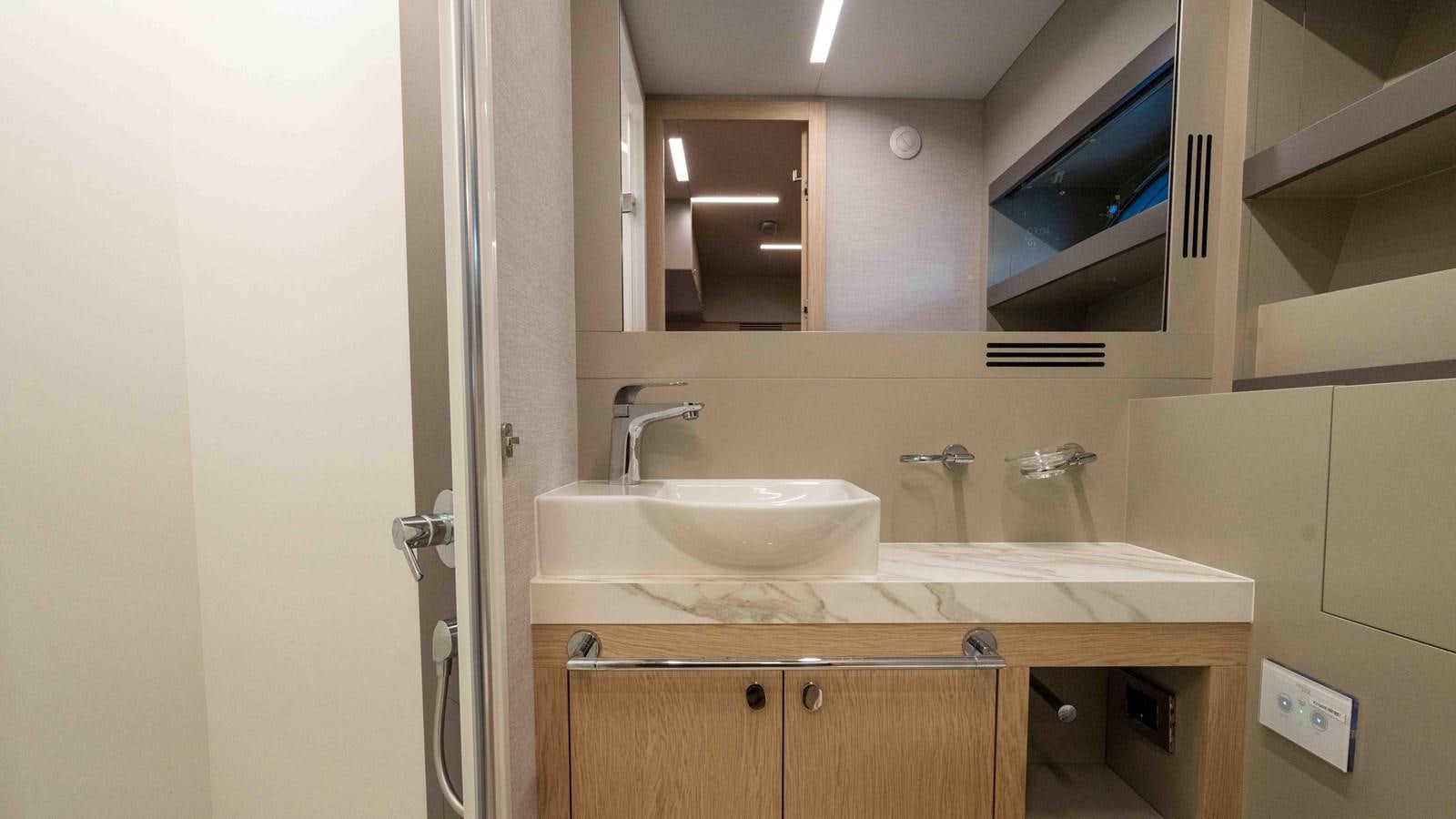 a bathroom with a sink and a mirror aboard ADONIS Yacht for Sale