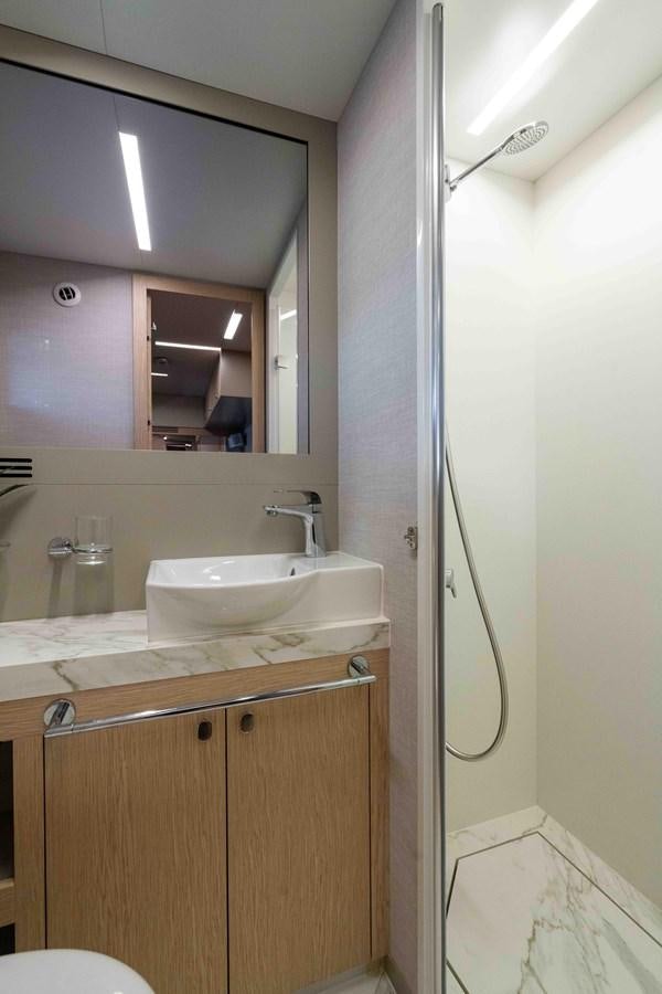 a bathroom with a sink and a mirror aboard ADONIS Yacht for Sale