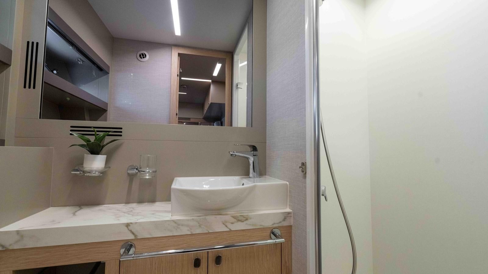 a bathroom with a large mirror aboard ADONIS Yacht for Sale
