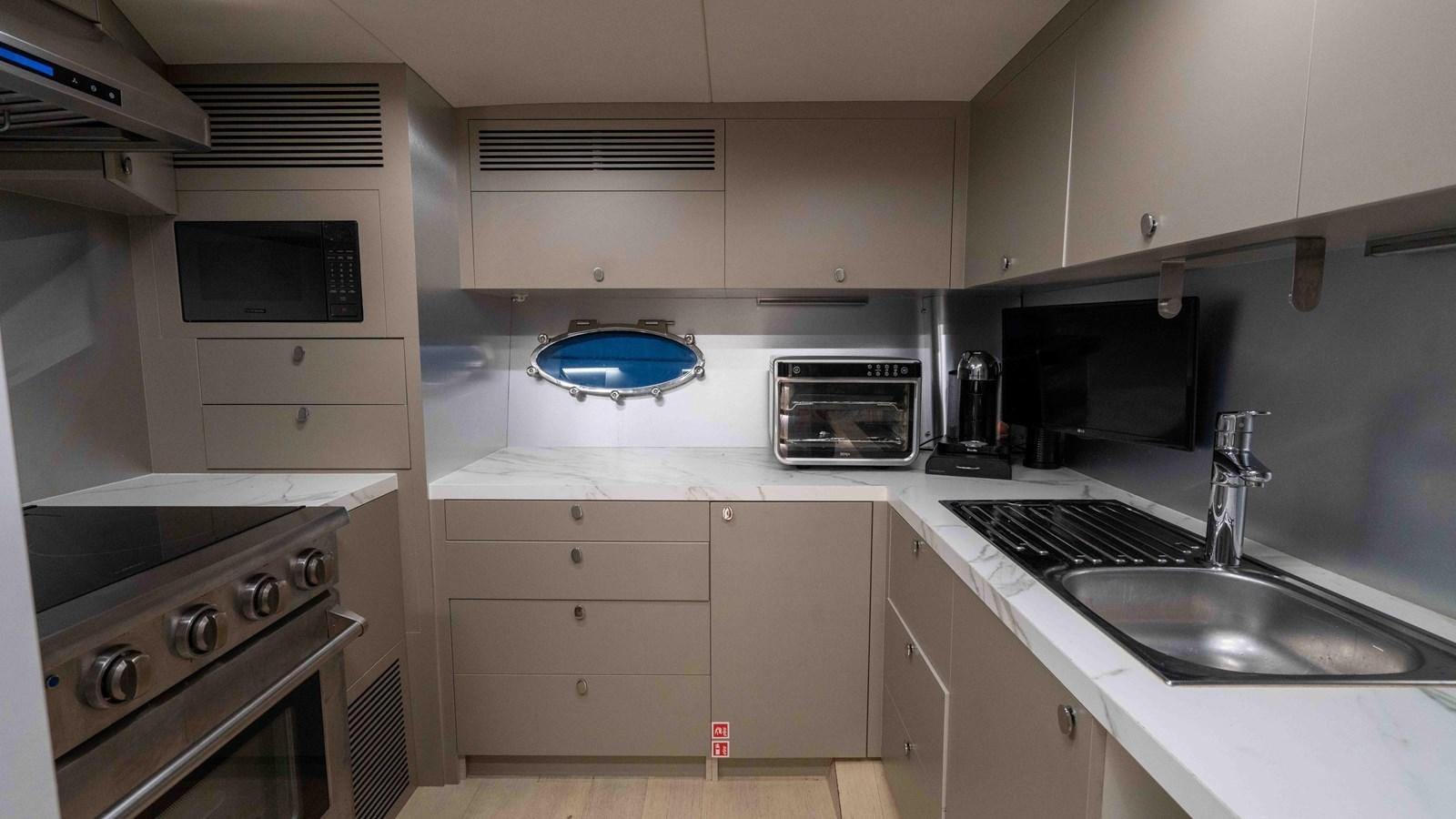 a kitchen with white cabinets aboard ADONIS Yacht for Sale