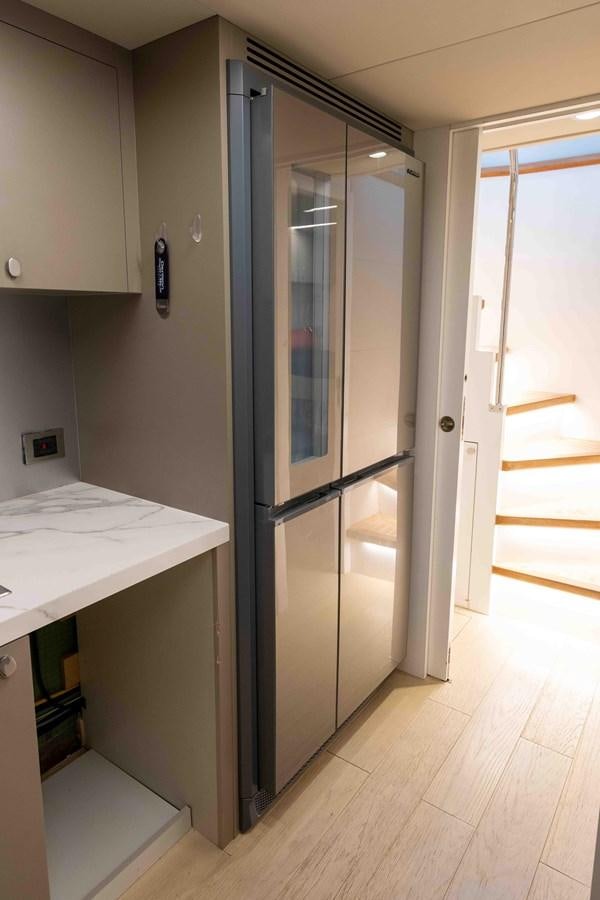 a refrigerator in a kitchen aboard ADONIS Yacht for Sale