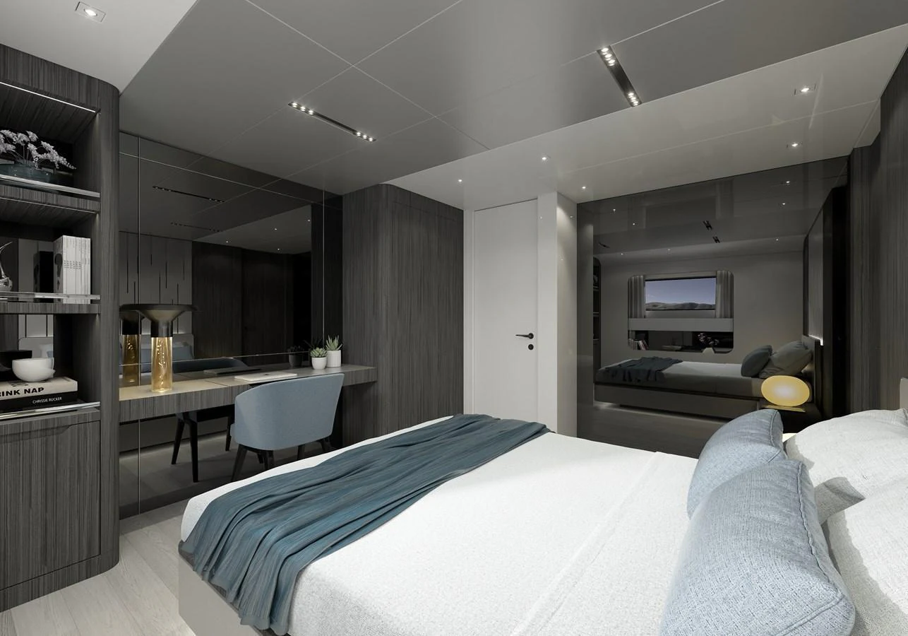 a bedroom with a bed and a desk aboard LEGASEA Yacht for Sale