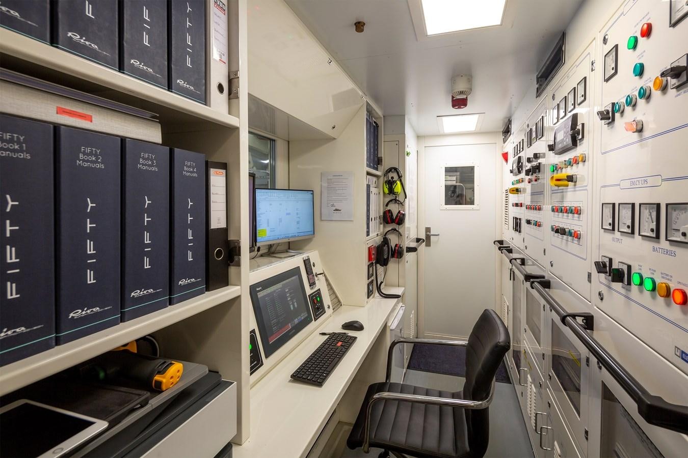 a room with computers and monitors aboard FIFTY Yacht for Sale