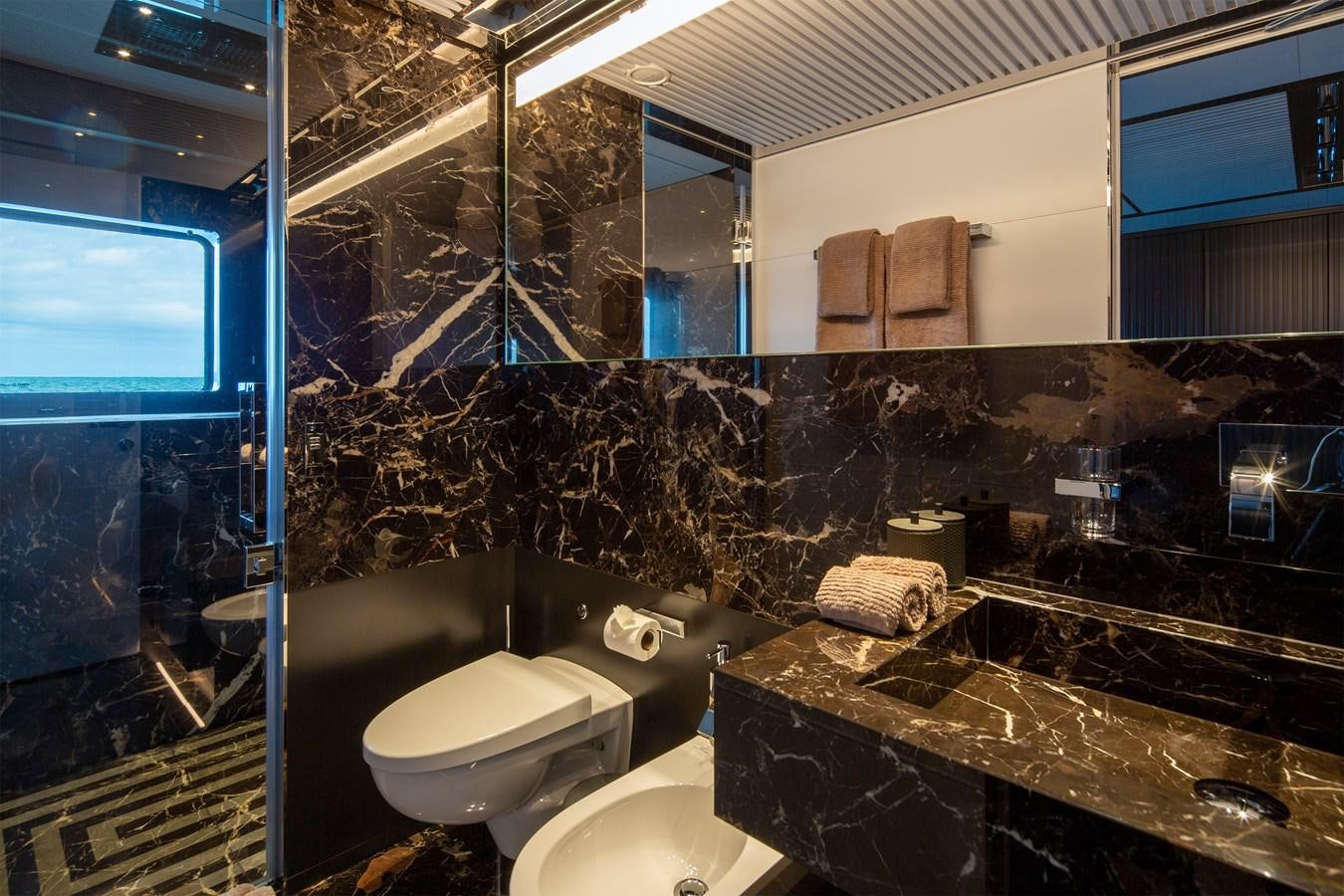 a bathroom with a glass shower aboard FIFTY Yacht for Sale