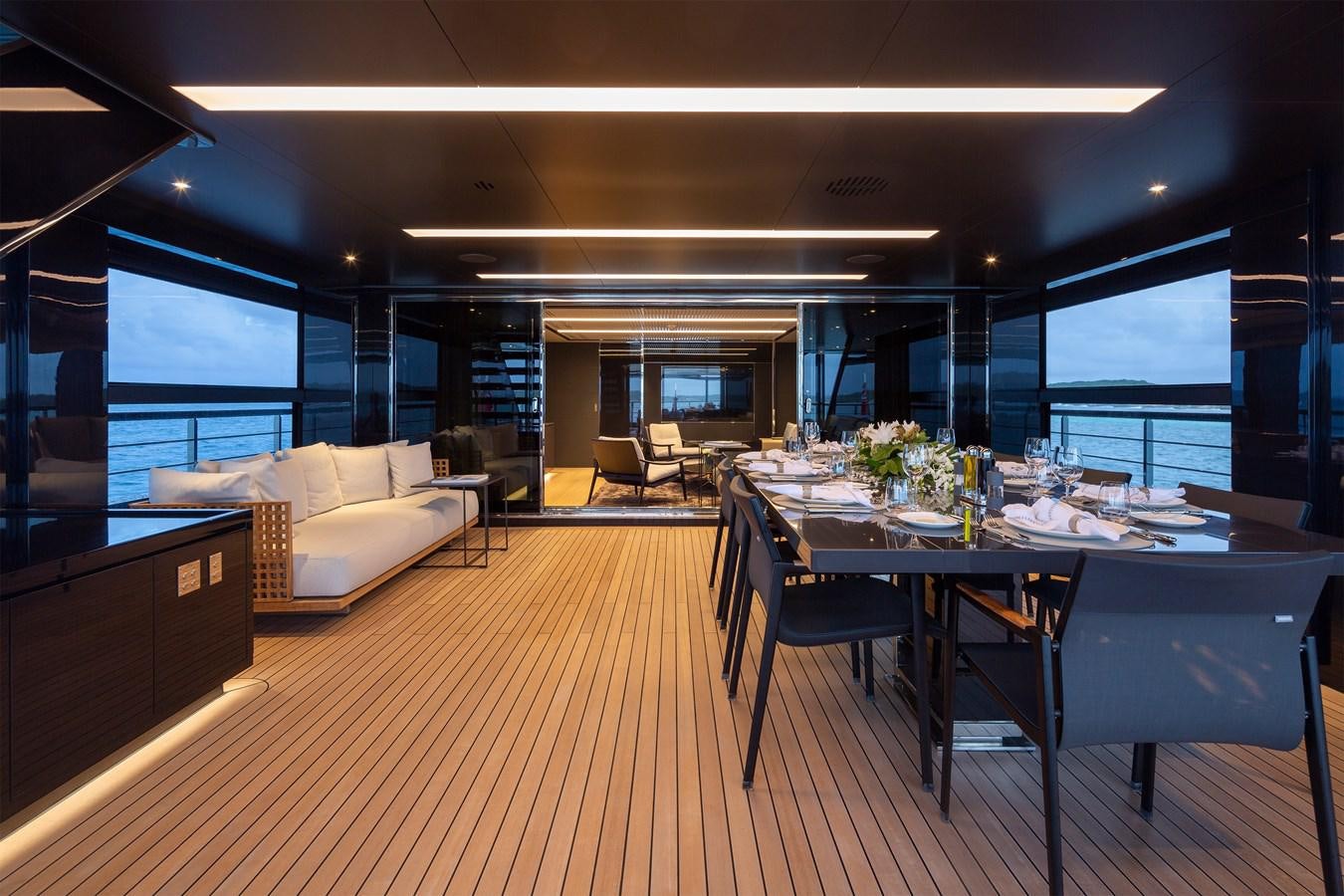 a room with a table and chairs aboard FIFTY Yacht for Sale