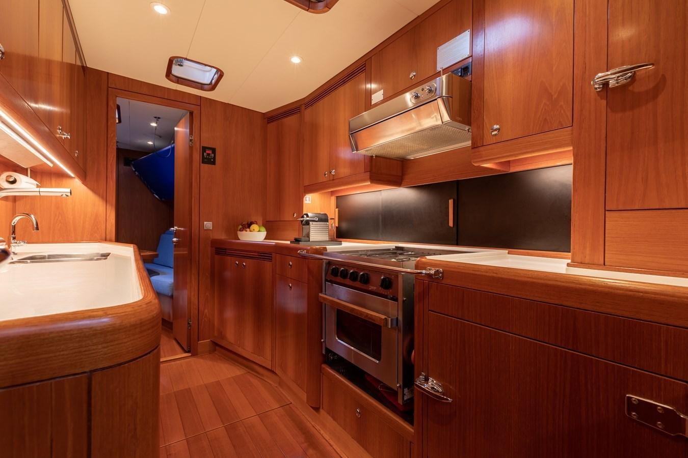 a kitchen with wooden cabinets aboard NAZCA 2 Yacht for Sale