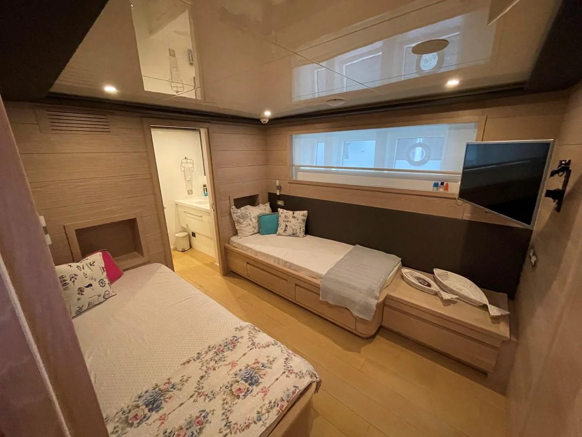 a room with a bed and a television aboard PENNON Yacht for Sale