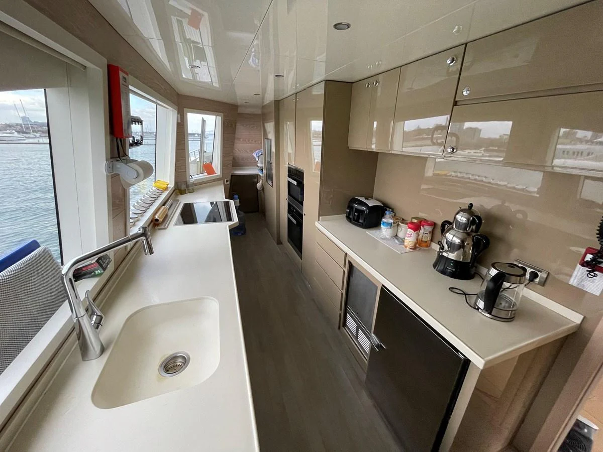 a kitchen with a sink and a window aboard PENNON Yacht for Sale
