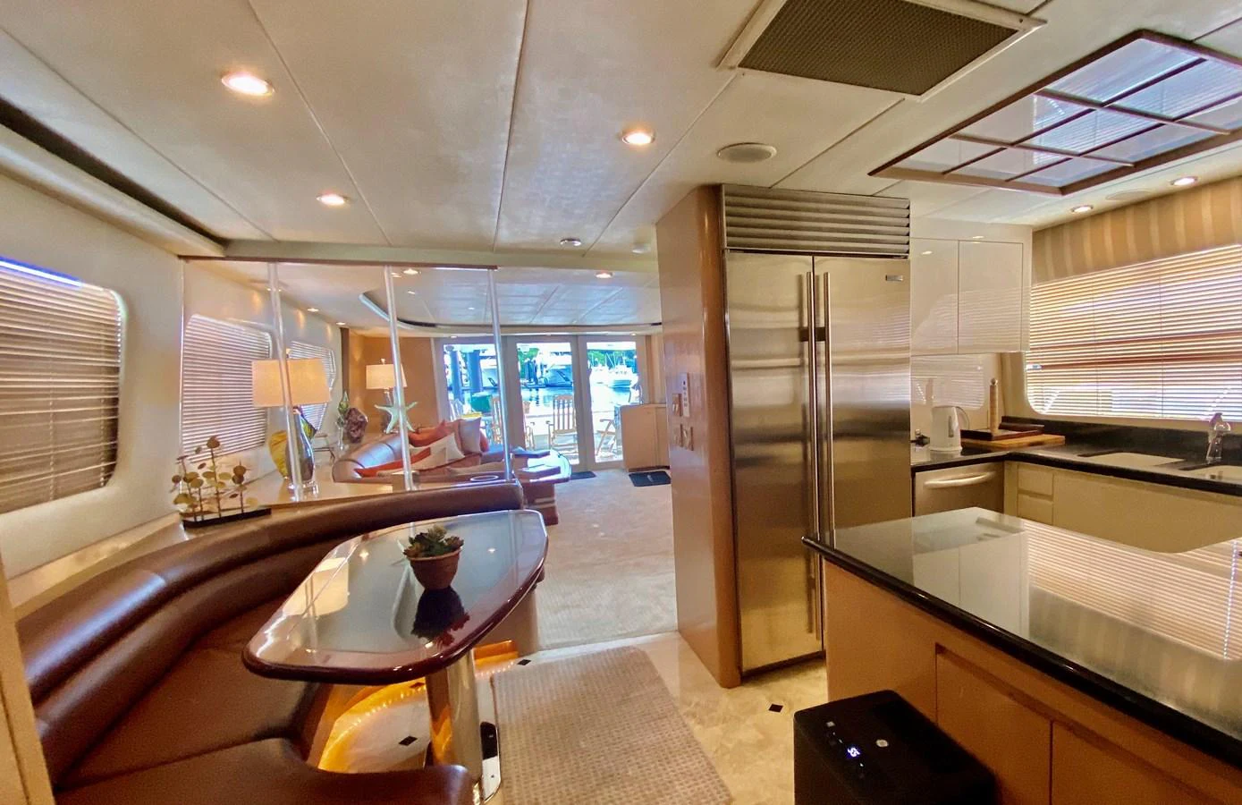 a kitchen with a table and refrigerator aboard SEAQUEST Yacht for Sale