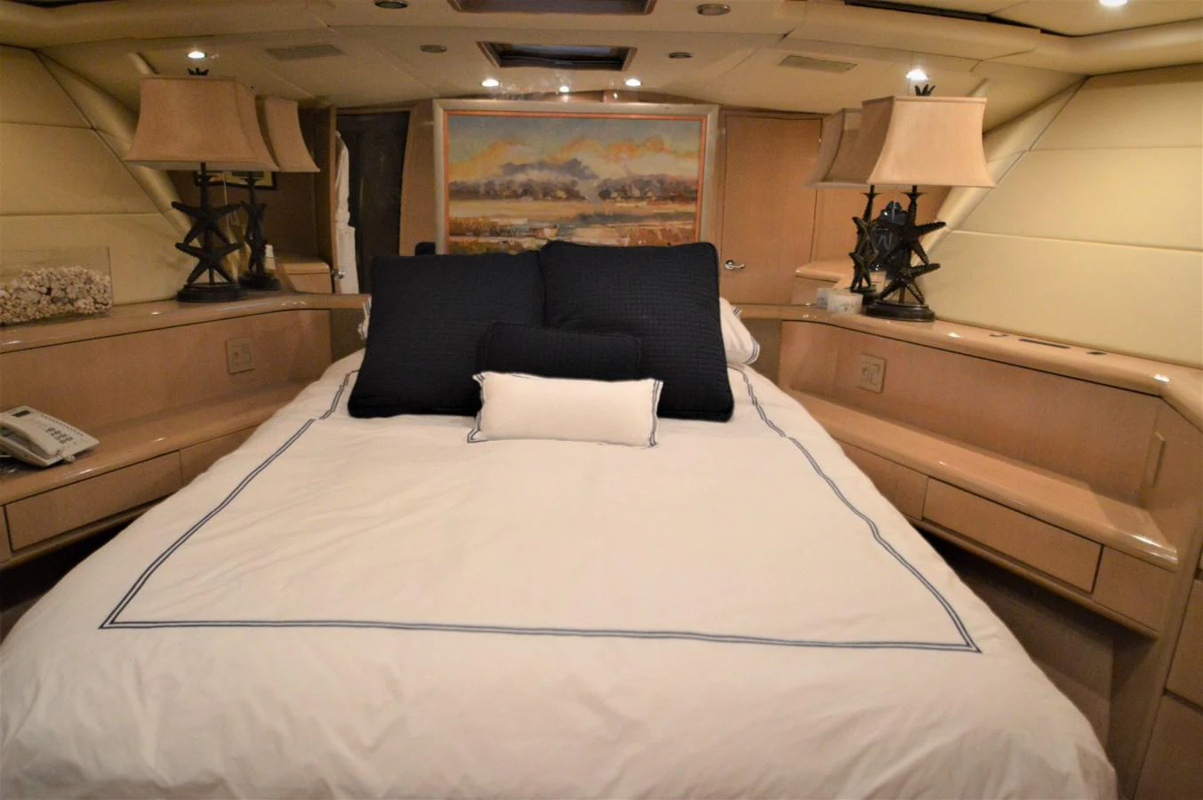 a bed with a blue pillow aboard SEAQUEST Yacht for Sale